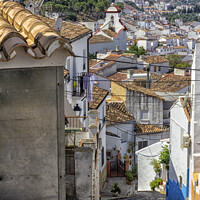 Buy canvas prints of Narrow, steep street overlooking Ubrique, by Kevin Hellon