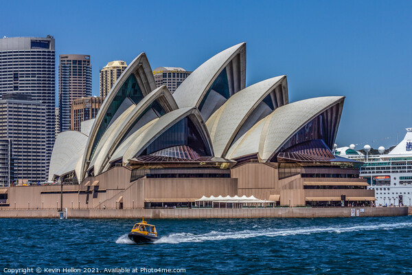 A boat powers past the Sydney Opera House, in the  Picture Board by Kevin Hellon