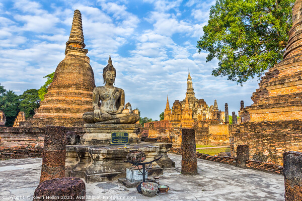 Buddha statue with Wat Mahathat in the background Picture Board by Kevin Hellon