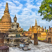 Buy canvas prints of Buddha statue with Wat Mahathat in the background by Kevin Hellon