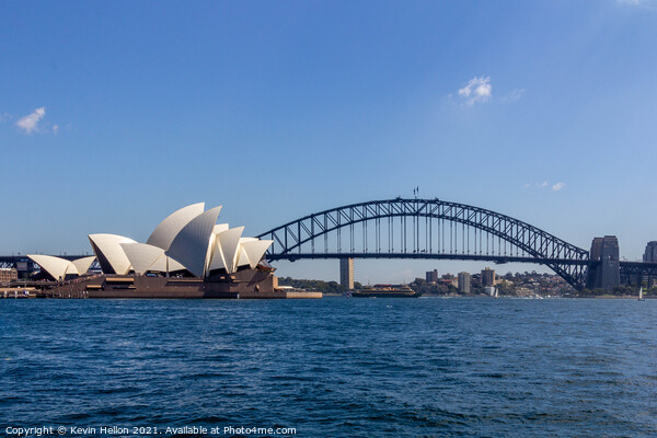 View of the Opera House in Sydney Harbor. The Sydney Harbour Bri Picture Board by Kevin Hellon