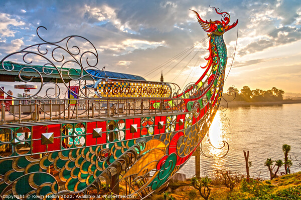 Dragon boat prow at sunset Picture Board by Kevin Hellon