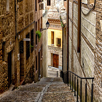 Buy canvas prints of Steep, narrow street in Toledo, Spain by Kevin Hellon