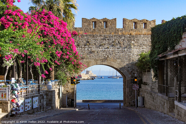 Looking through a gateway to the harbour, Rhodes Town, Greece Picture Board by Kevin Hellon