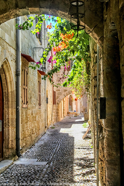 Narrow street in Rhodes old town, Greece Picture Board by Kevin Hellon