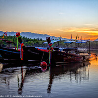Buy canvas prints of Long tail boats moored in Psk Meng, Trang Province at sunrise. by Kevin Hellon