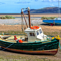 Buy canvas prints of Boats moored in Red Wharf Bay, Anglesey at low tid by Kevin Hellon