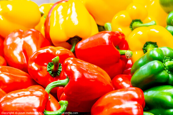 Red, yellow and green peppers on a market stall Picture Board by Kevin Hellon