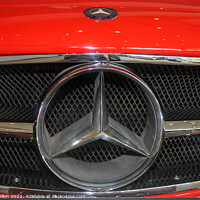 Buy canvas prints of Mercedes badge on a red car. by Kevin Hellon