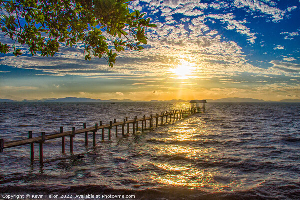 Sunrise over a pier in Phang Nga Bay Picture Board by Kevin Hellon