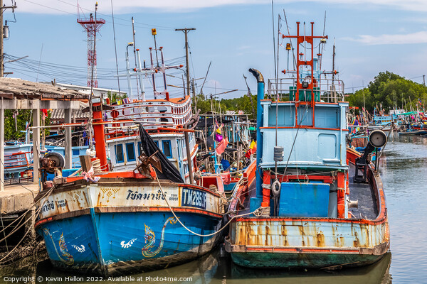 Thai fishing boats in harbour Picture Board by Kevin Hellon