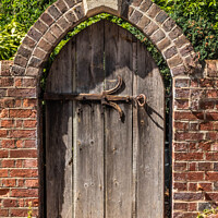 Buy canvas prints of Old wooden gate with wrought iron fittings  by Kevin Hellon
