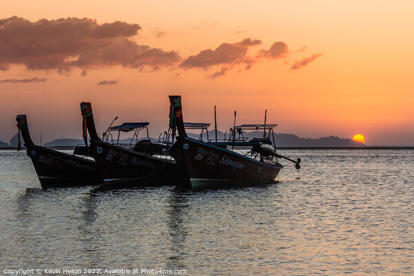 Long tail boats at sunrise. Picture Board by Kevin Hellon