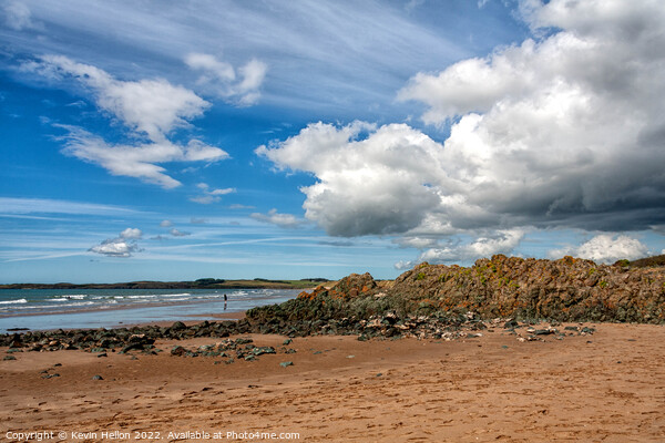 Volcanic rock, blue sky and clouds on Newborough beach, Anglesey Picture Board by Kevin Hellon