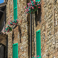Buy canvas prints of Colourful shutters on a house in Bevagna, Umbria, Italy by Kevin Hellon