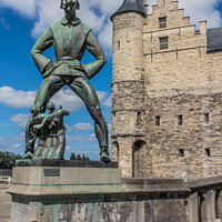 Buy canvas prints of Bronze statue of De Lange Wapper and Het Steen, historic castle, by Kevin Hellon