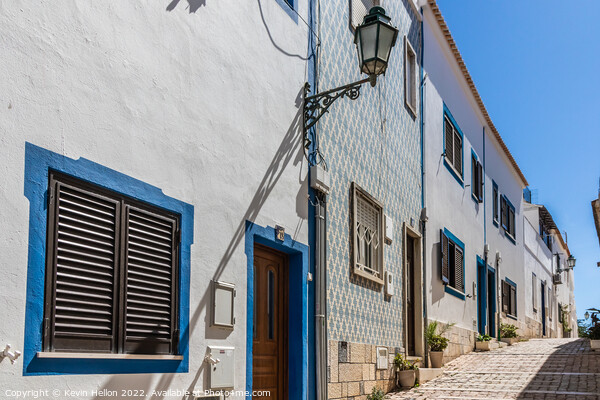 Narrow, steep street, Albufeira old town, Picture Board by Kevin Hellon