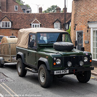 Buy canvas prints of Landrover Defender pulling truck with a bale of hay, by Kevin Hellon
