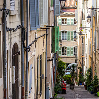 Buy canvas prints of Steep, narrow street in old Marseille, France by Kevin Hellon