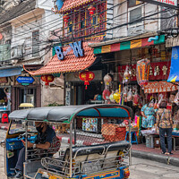 Buy canvas prints of Tuk tuk in a street in Chinatown. by Kevin Hellon