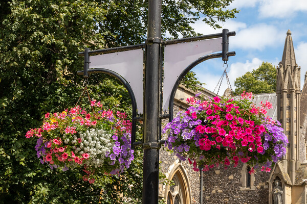 Hanging baskets outside St Marys Church, High Wycombe Picture Board by Kevin Hellon