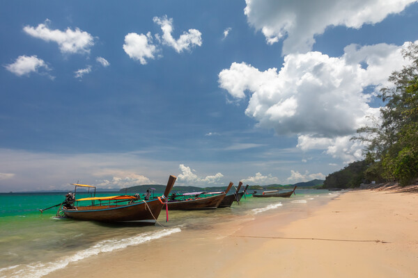 Long tail boat moored at Ao Nang Beach Picture Board by Kevin Hellon