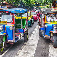 Buy canvas prints of Tuk tuks on a street in the city. by Kevin Hellon