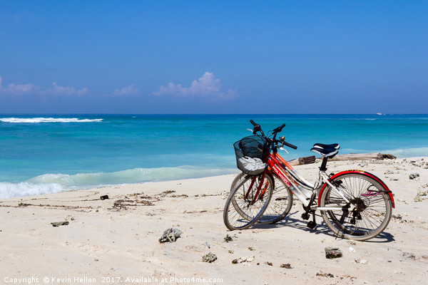Bicycles on a white sand beach Picture Board by Kevin Hellon