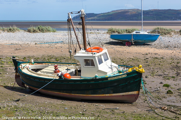 Boats moored in Red Wharf BayAnglesey at low tide. Picture Board by Kevin Hellon
