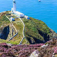 Buy canvas prints of A yacht sails past the North Stack lighthouse by Kevin Hellon