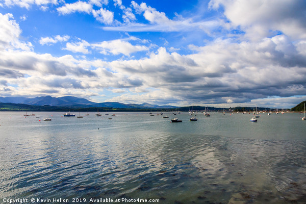 Blue sky and clouds over boats moored in the Menai Picture Board by Kevin Hellon