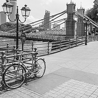 Buy canvas prints of Bicycle leaning against railings with Cavenagh Bri by Kevin Hellon