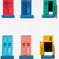 Buy canvas prints of Colourful windows on a building by Kevin Hellon