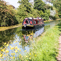 Buy canvas prints of A narrowboat makes its way along the Grand Union c by Kevin Hellon