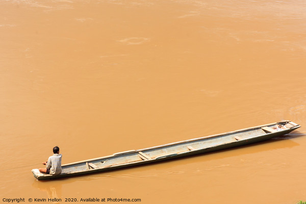 Man in boat on the Mekhong River  Picture Board by Kevin Hellon