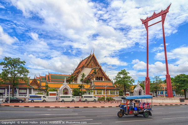 A tuk tuk drives past the Giant Swing Picture Board by Kevin Hellon