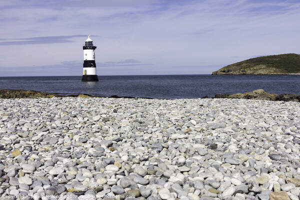 Penmon lighthouse and shingle beach Picture Board by Kevin Hellon