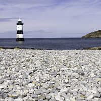 Buy canvas prints of Penmon lighthouse and shingle beach by Kevin Hellon