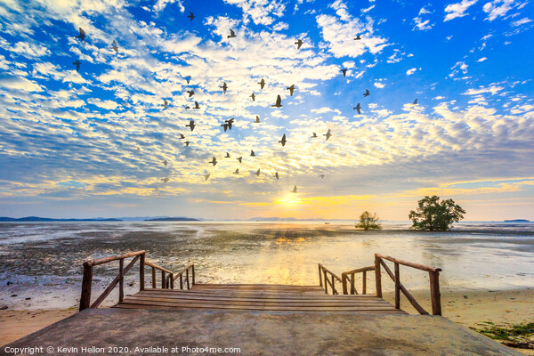 Sunrise with sunrays and flock of birds Picture Board by Kevin Hellon