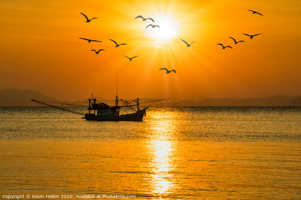 Fishing boat at sunset Picture Board by Kevin Hellon