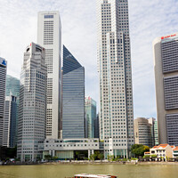 Buy canvas prints of Bumboat on the Singapore river with the tall buildings of the fi by Kevin Hellon
