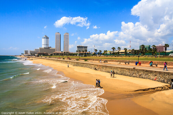 People walking on Galle Face beach Picture Board by Kevin Hellon