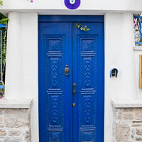 Buy canvas prints of Blue door and entrance to a house  by Kevin Hellon