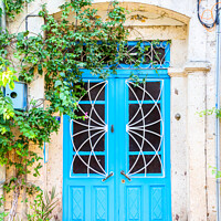 Buy canvas prints of Blue door on house by Kevin Hellon