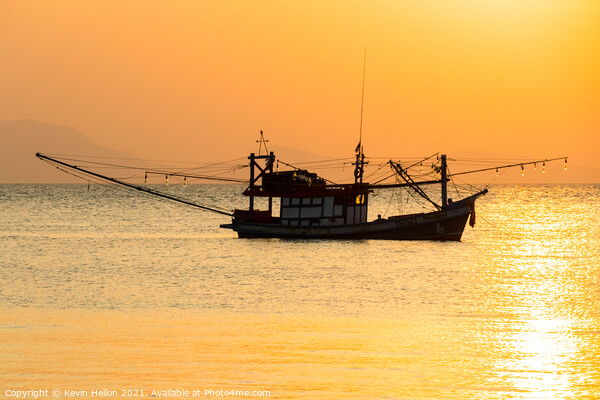 Fishing boat at sunset Picture Board by Kevin Hellon