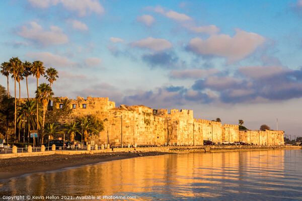 Early morning sunlight bathes the castle of Kos Picture Board by Kevin Hellon