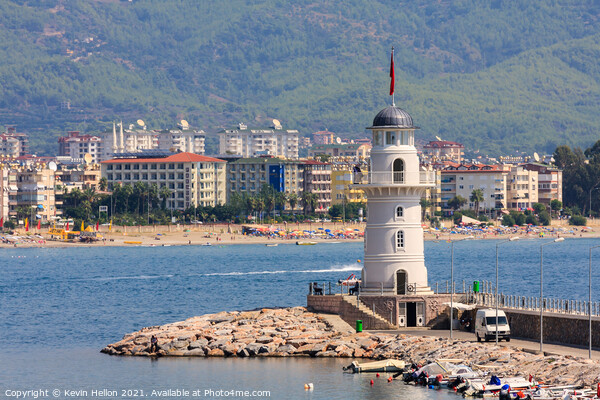 The lighthouse guarding the entrance to Alanya harbour Picture Board by Kevin Hellon