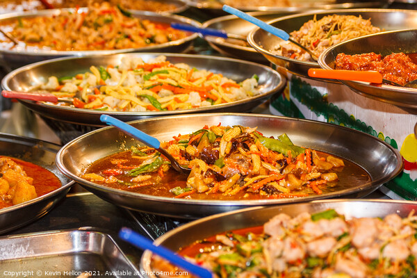 Platters of Thai food on a street food stall Picture Board by Kevin Hellon