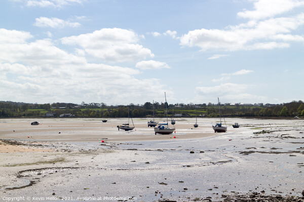 Boats moored in Red Wharf Bay Anglesey at low tide Picture Board by Kevin Hellon