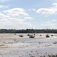 Buy canvas prints of Boats moored in Red Wharf Bay Anglesey at low tide by Kevin Hellon